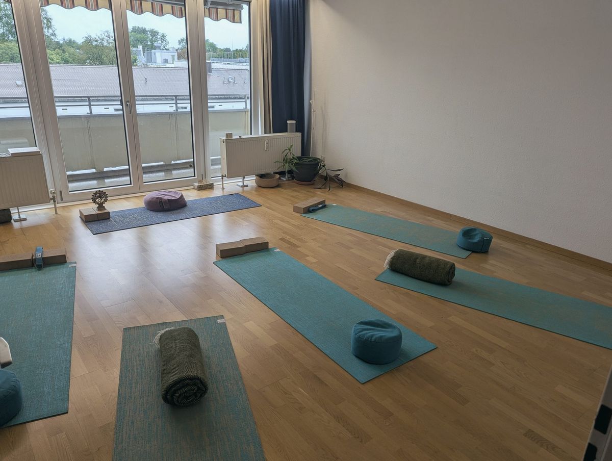 The studio: wooden floor, teal mats laid out, large windows